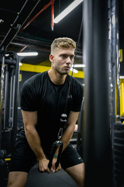 Man exercising with resistance bands in a gym setting